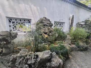 Rocks and white walls in a classical garden