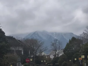 A snowy mountain behind a quiet town